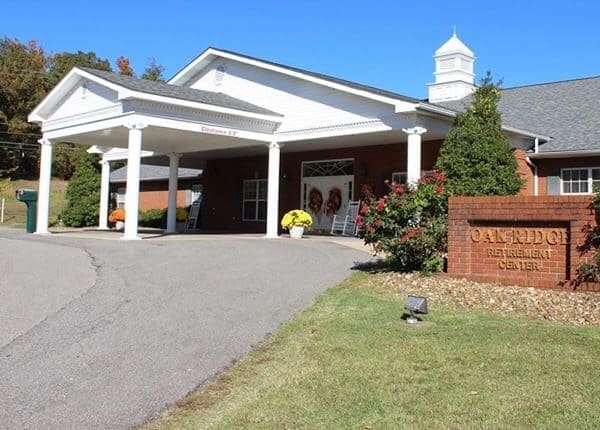 Stone Haven Developments A single-story brick building with a covered entrance; a sign in front reads “Oak Ridge Retirement Center.” Developed by Stone Haven Developments, shrubs and flowers are planted along the walkway. Ontario